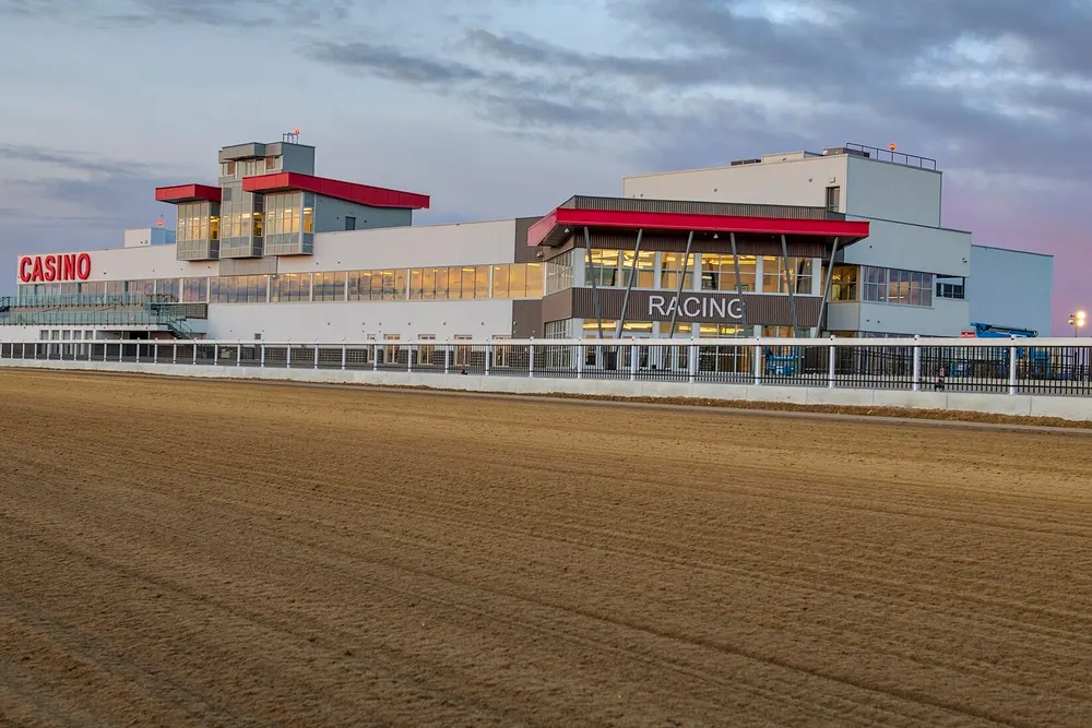 Century Mile grandstand at dusk, seen across the dirt racetrack